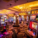 Interior view of a casino with empty slot machines and decorative lighting